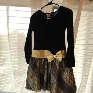 Black velvet top with gold bow.Skirt has multi colors.